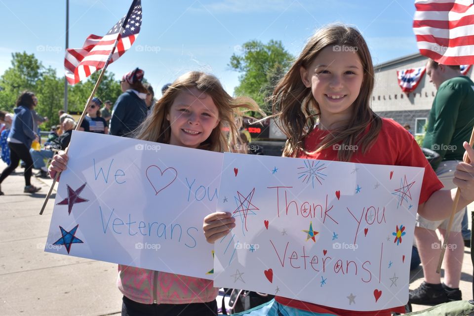 Memorial Day Parade. Two girls stand in support for veterans during the annual memorial day parade.