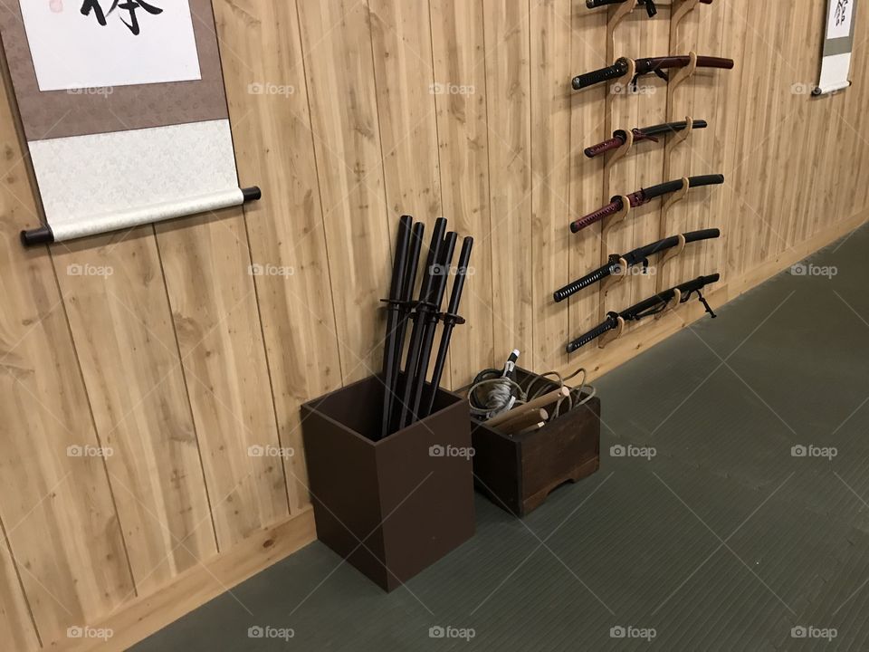 Bokken and other training weapons organized in their boxes. An impressive sight at the dojo.