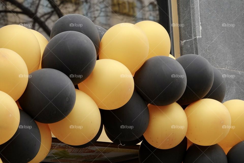 Group of yellow and black helium balloons. Holiday, congratulation, concept, close-up.