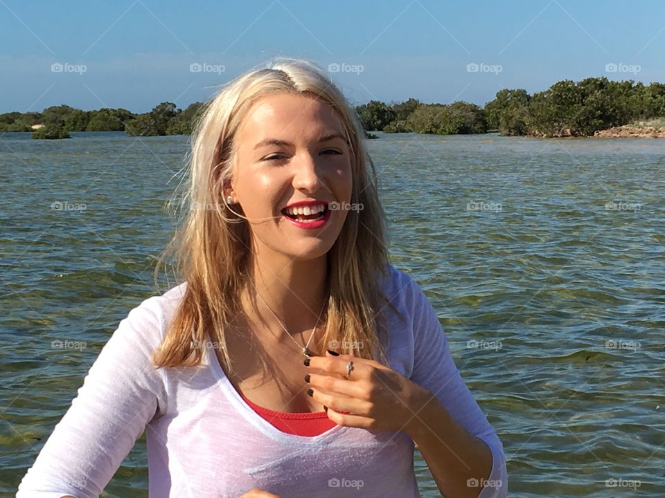 Laughing woman against lake