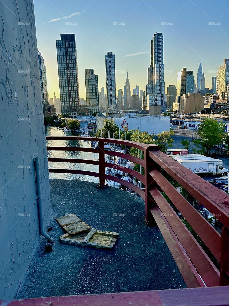 This is the center outpost of the “Pulaski Bridge” at “Newtown Creek” that connects “Greenpoint”, Brooklyn to LIC, Queens. Across the “East River” we see “Manhattan” including the “Empire State Building”. 2024. Hypnotic Productions