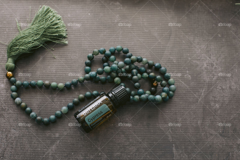 Cypress doterra essential oil bottle with mala beads 