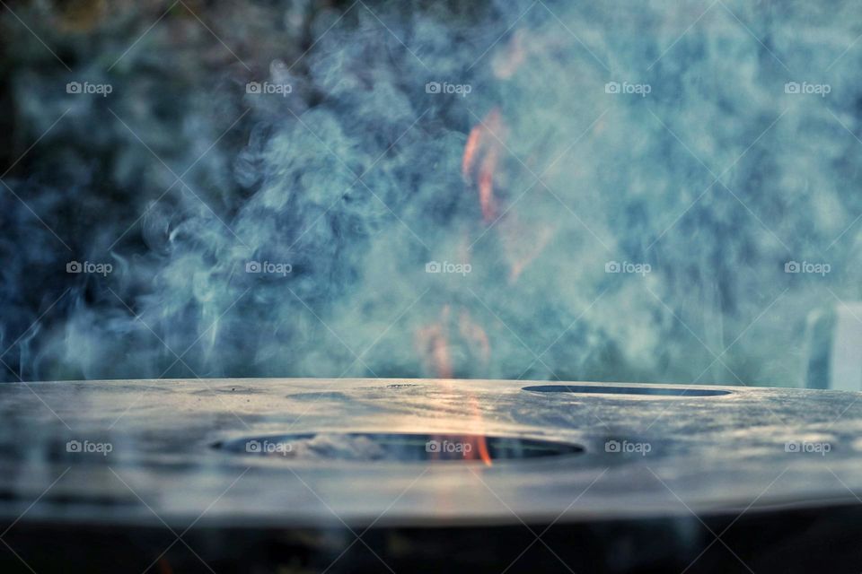 Smoke and fire on Barbecue in nature