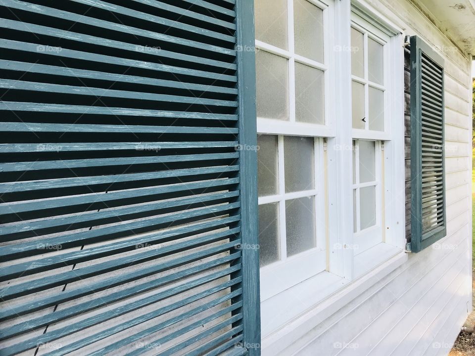Shutters on an abandoned building different angle