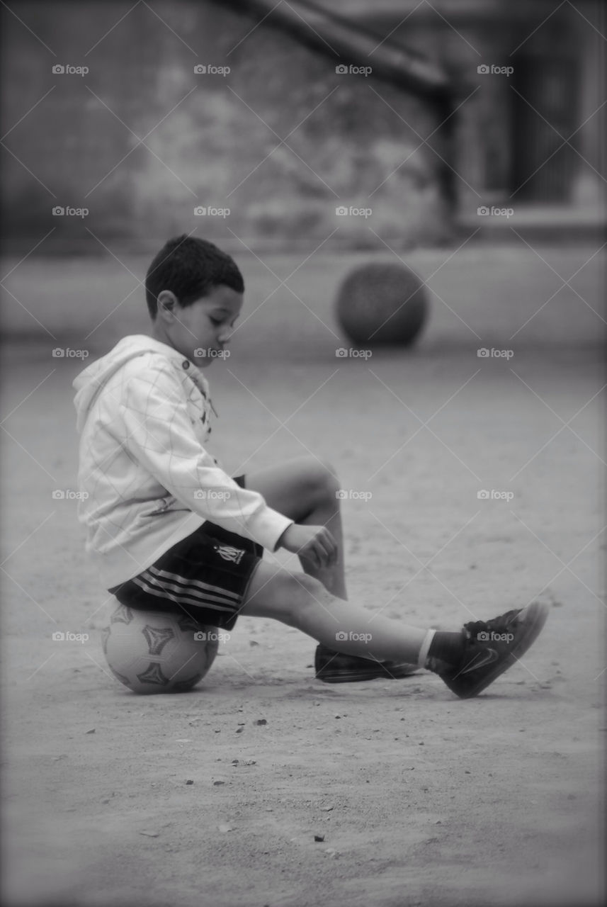 Boy sitting on ball