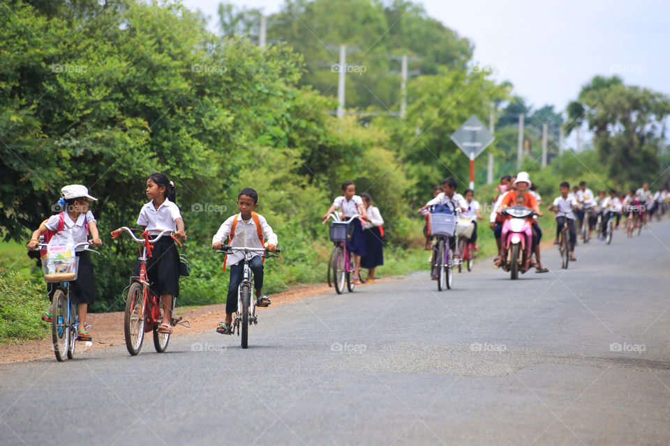 All kids back to school. I shooting this picture a long the street near kampong Chhnang province, Cambodia.