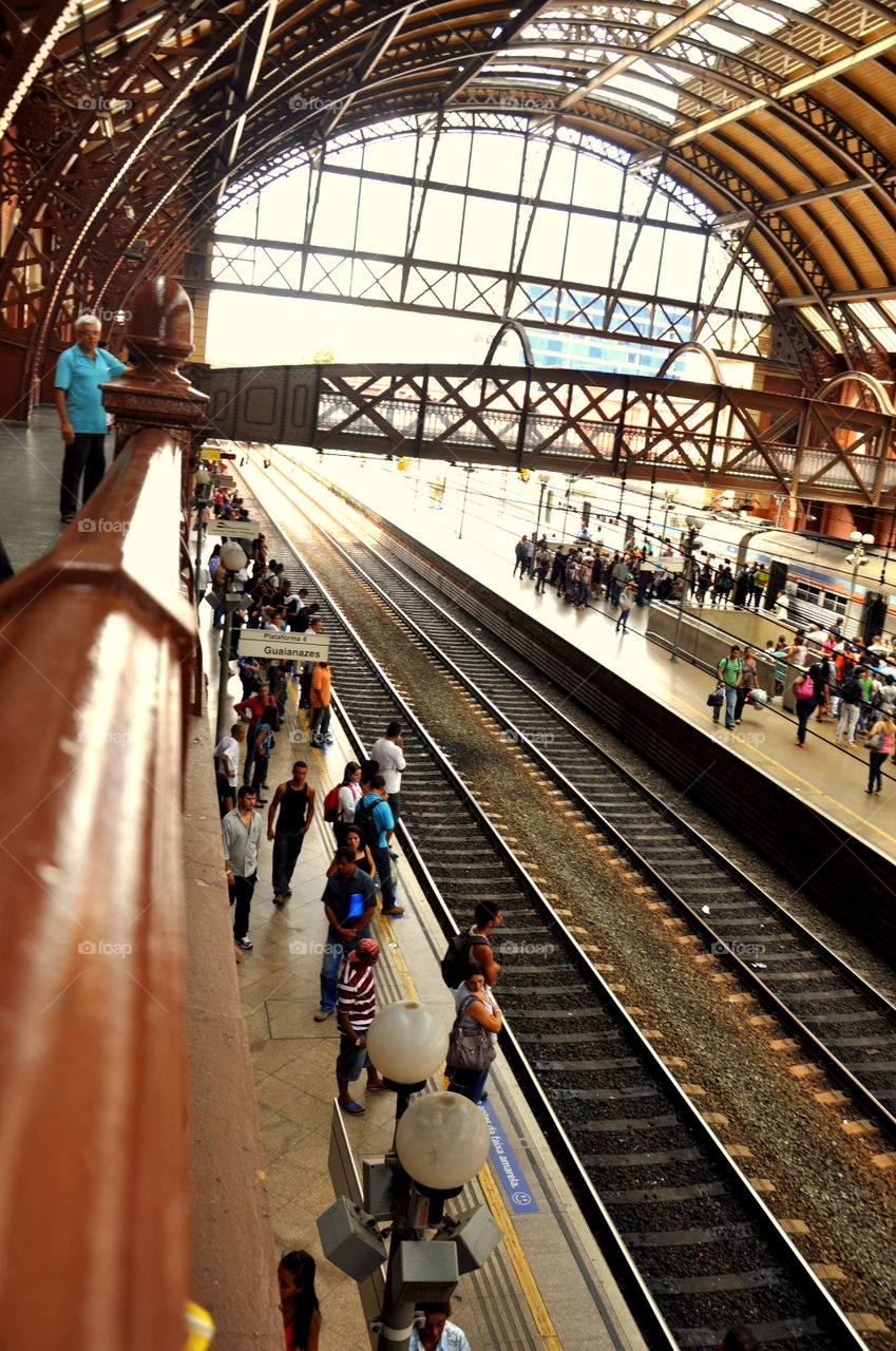 Rails and people in a busy metro station in downtown São Paulo