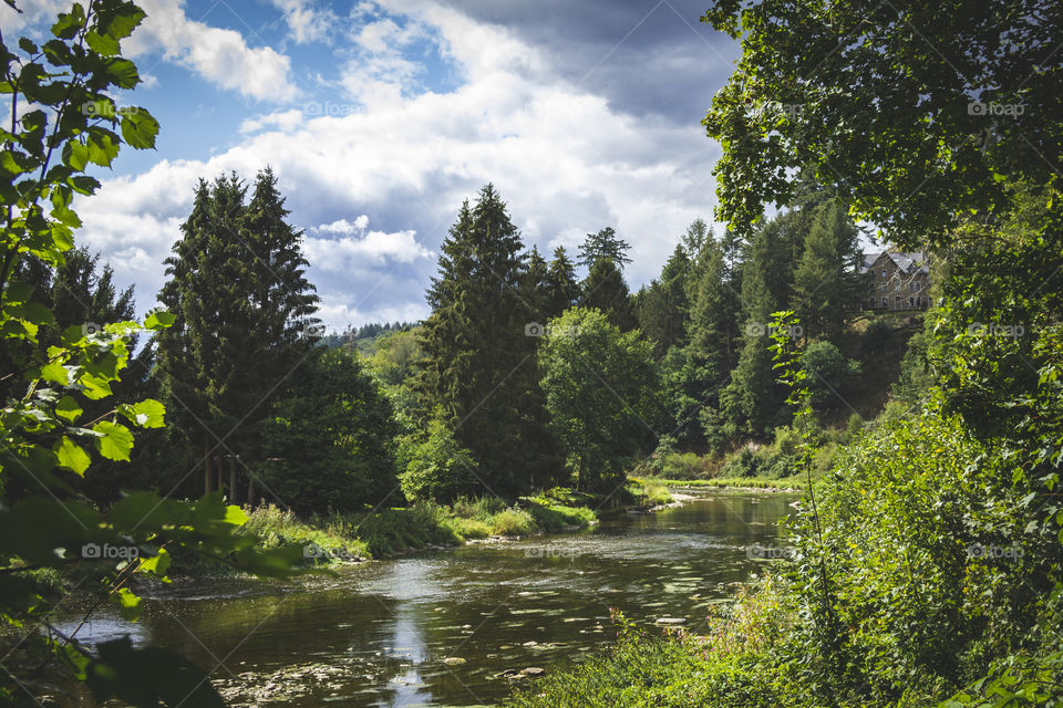 A portrait of a river through a mountain area with in a forest. there is also a house creeping in at the rightside of the foto. It was really beautiful and fun hiking there.