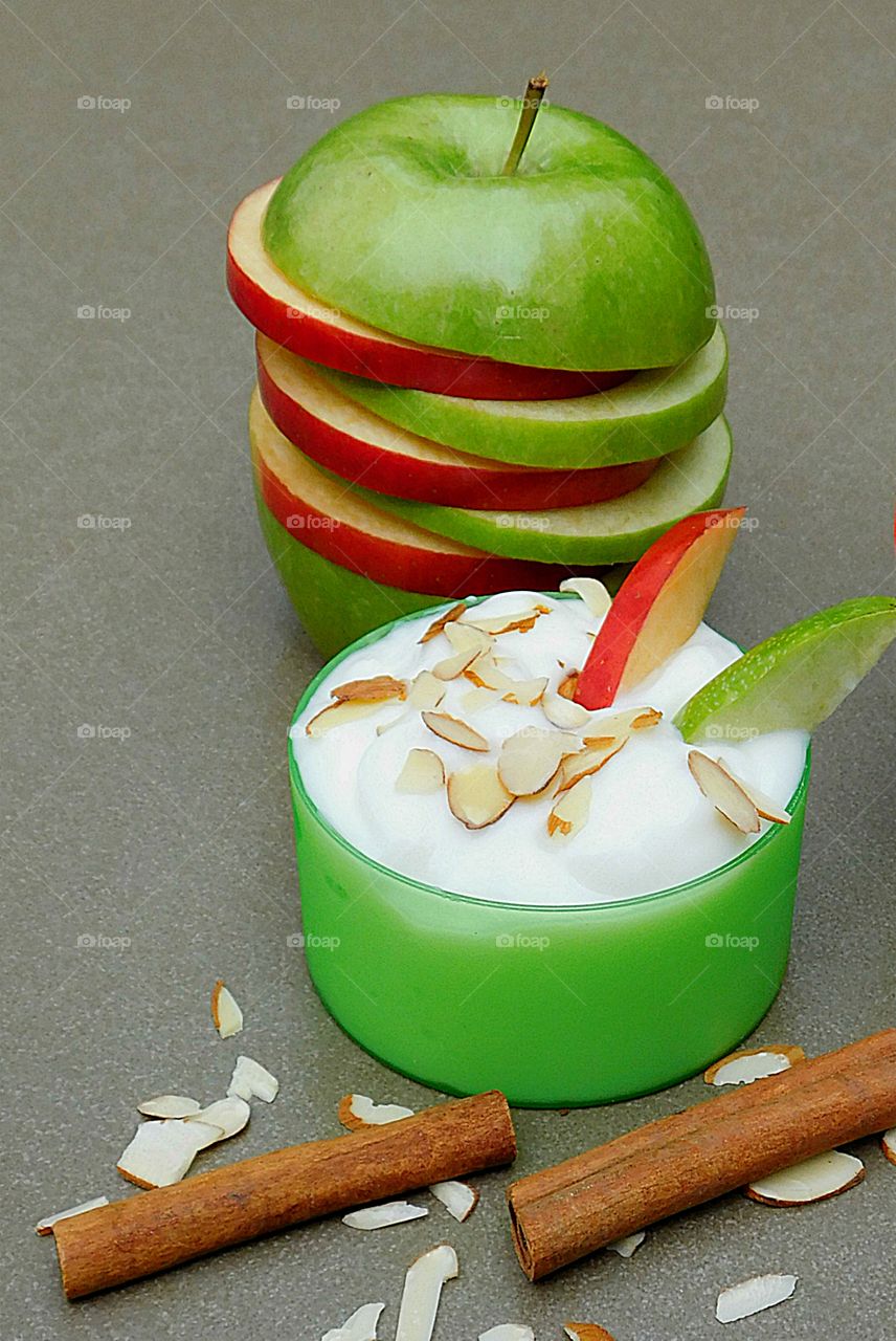 Apple Delight - variegated, red, green apples, colorful, color green, yogurt, tasty, delicious, slices, almond slivers, cup, fish, still life, cinnamon sticks, toppings, display, creative, ingredients, eat, table, breakfast, interesting, vivid, 