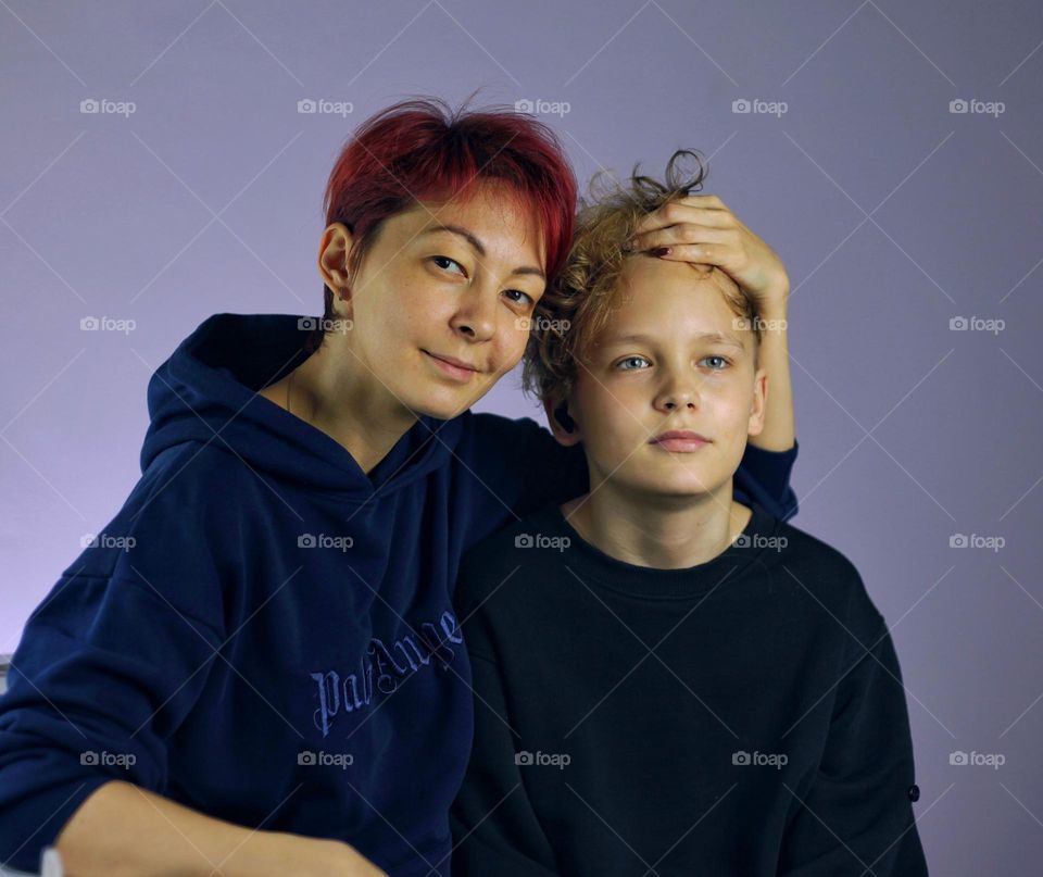 mother and son fool around in front of the camera and hug