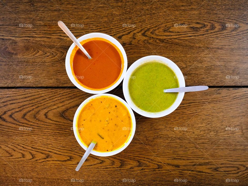 High angle view of spicy curry, dhal and mint sauce to company the chicken tandoori set meal