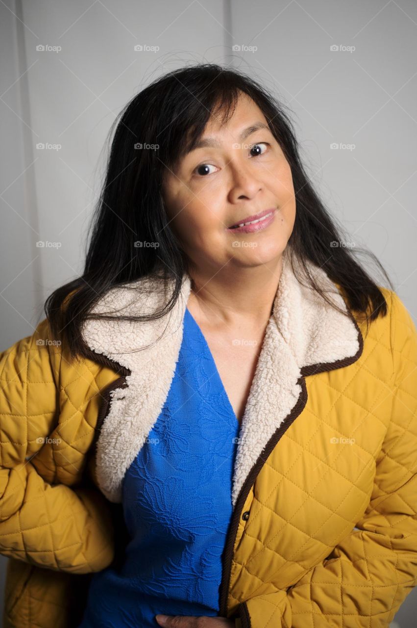 Fun portrait of a woman wearing yellow and purple top