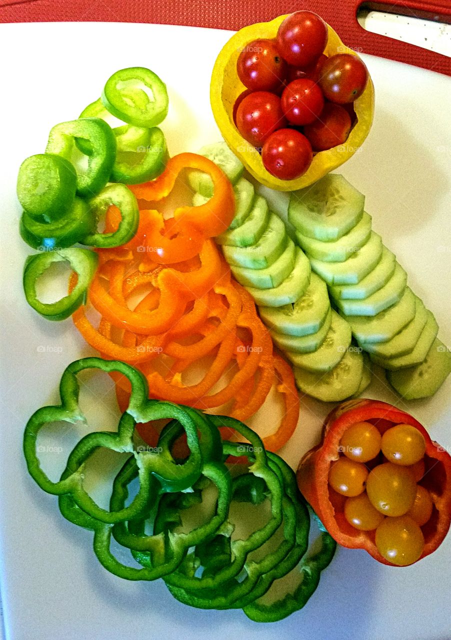 Bell Peppers, Cucumbers and Cherry Tomatoes being prepared for a  Platter of vegetable appetizers!