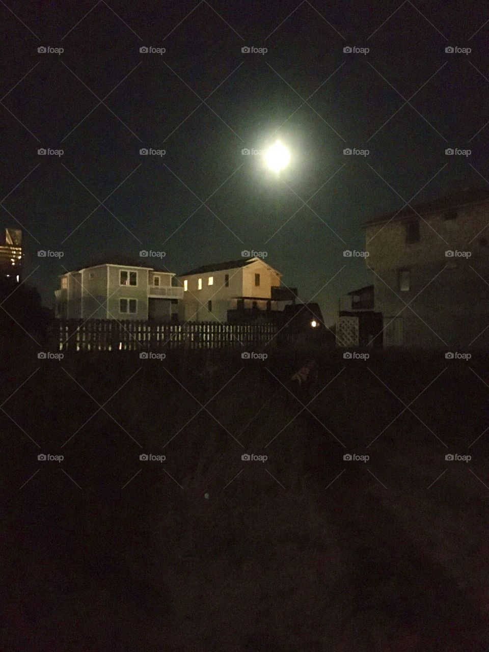 Full moon over beach cottages