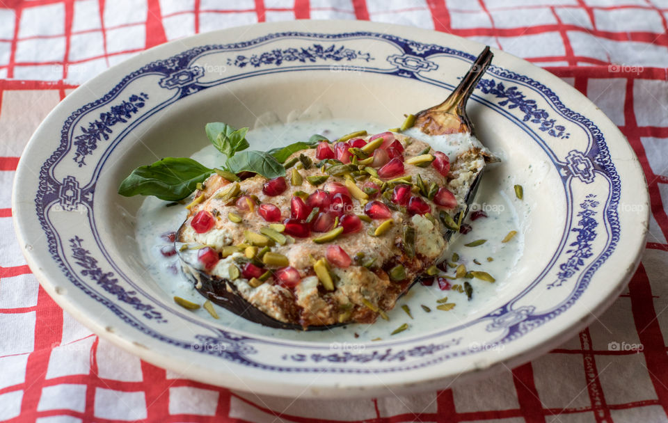 Baked eggplant with feta cream sauce, and pistachios and pomegranate seeds 