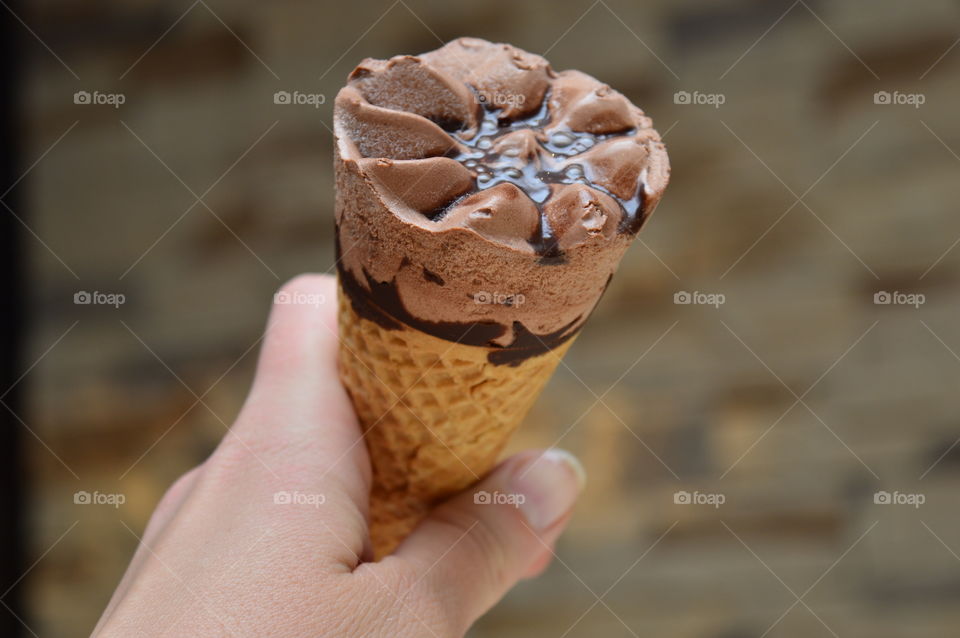 Person's hand holding ice cream