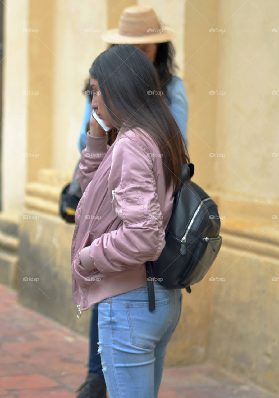 Girl walking and talking by phone 