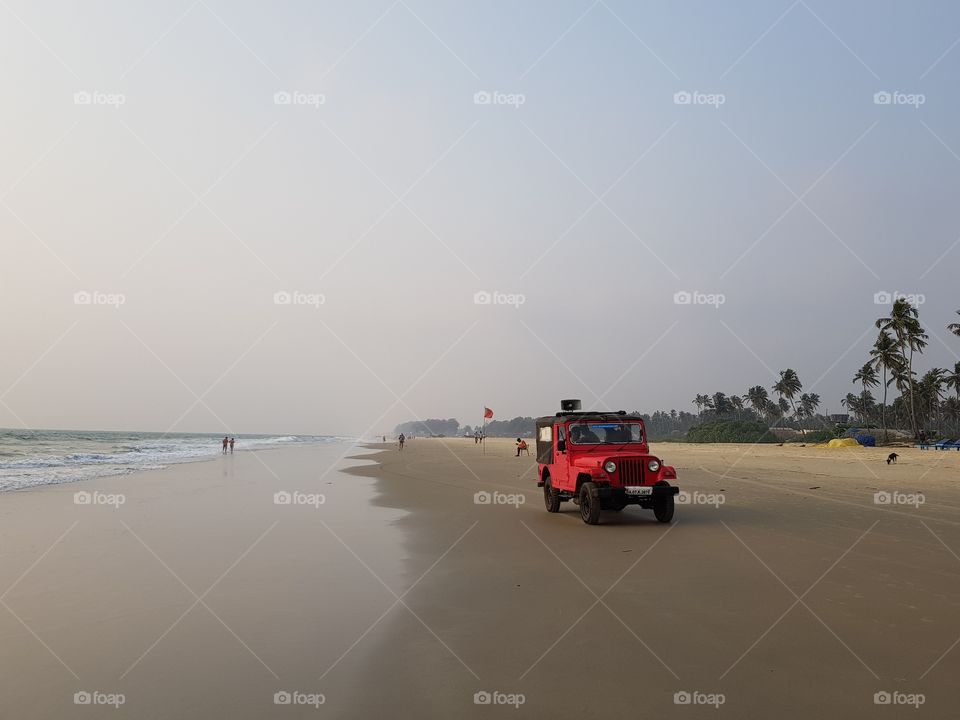 Red car on the beach
