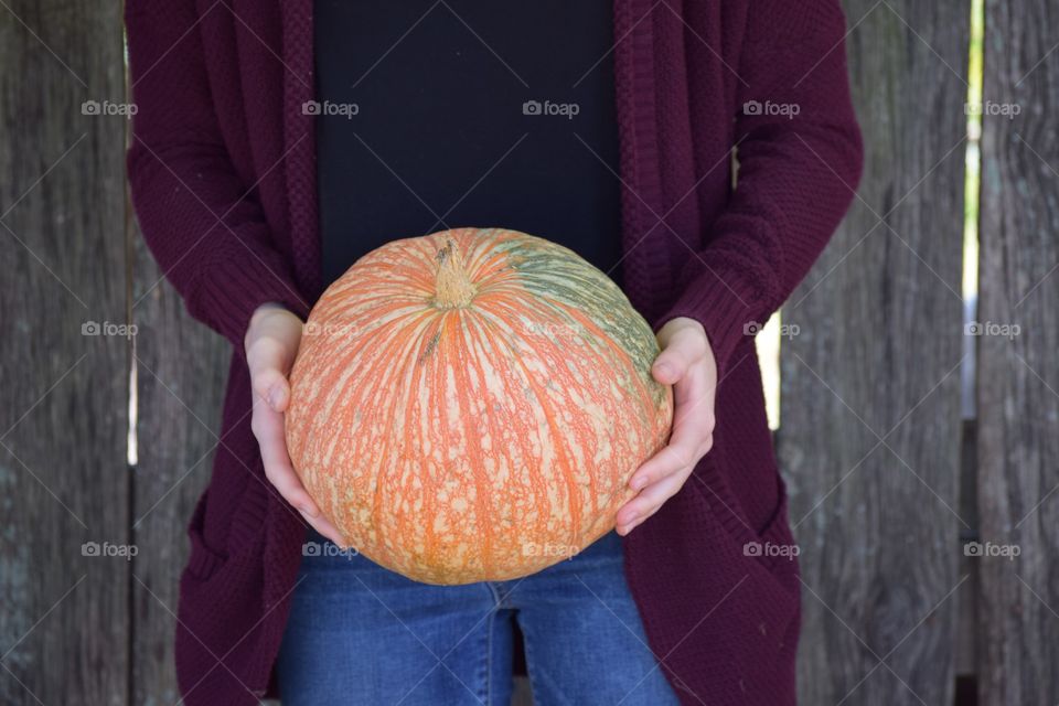 Close-up of hand holding pumpkin