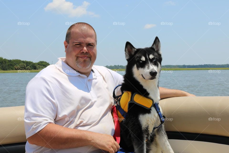 Dave and Yukon on the boat. Son &puppy on boat. dog loves it.