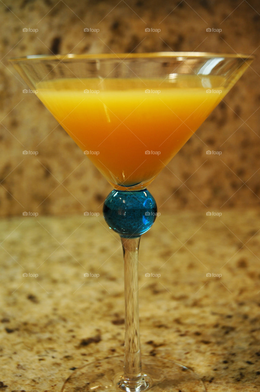 Orange cocktail in a beautiful glass.