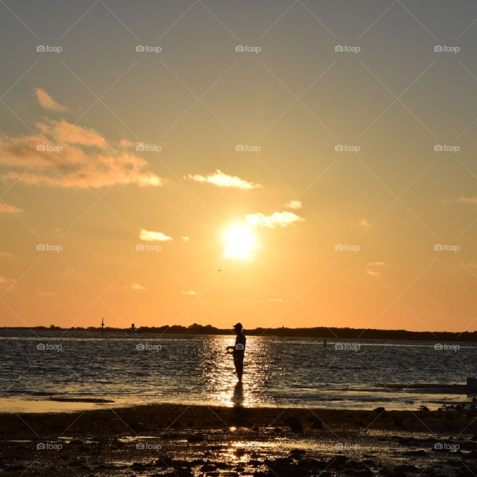 Sunset picture of a man fishing
