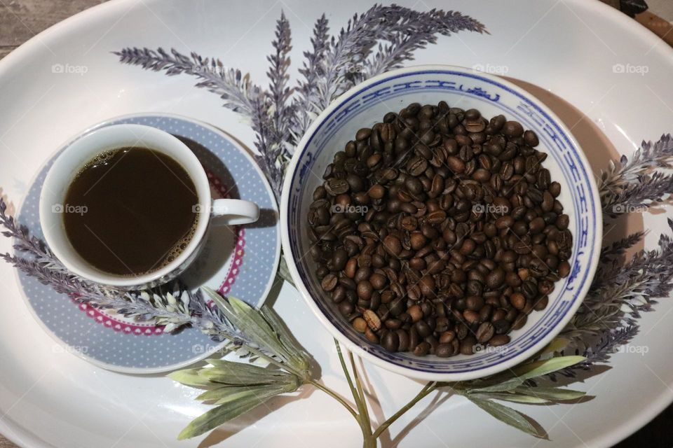 A cup of coffee and coffee beans