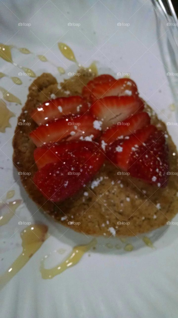 strawberry pancakes with strawberries and powdered sugar honey