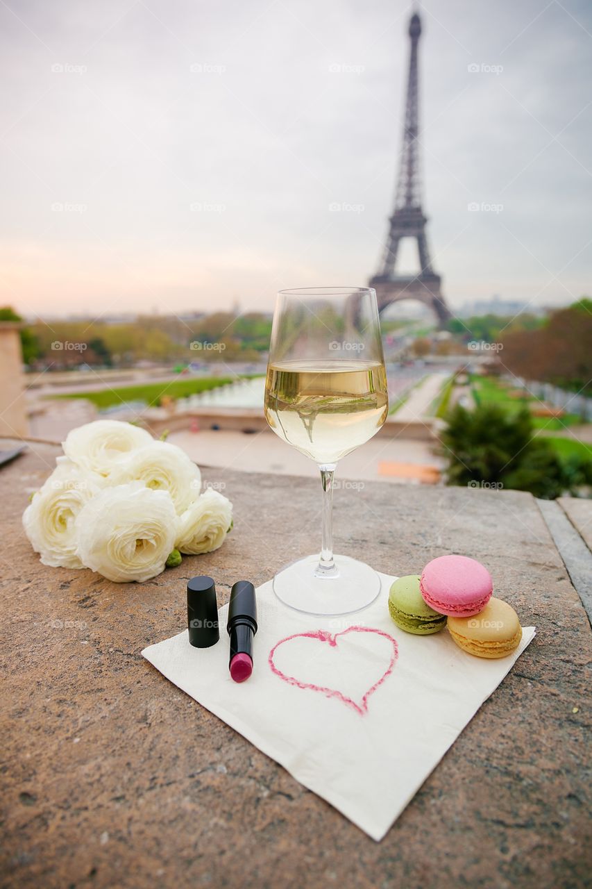 Wine glasses with croissant on the Eiffel Tower background 