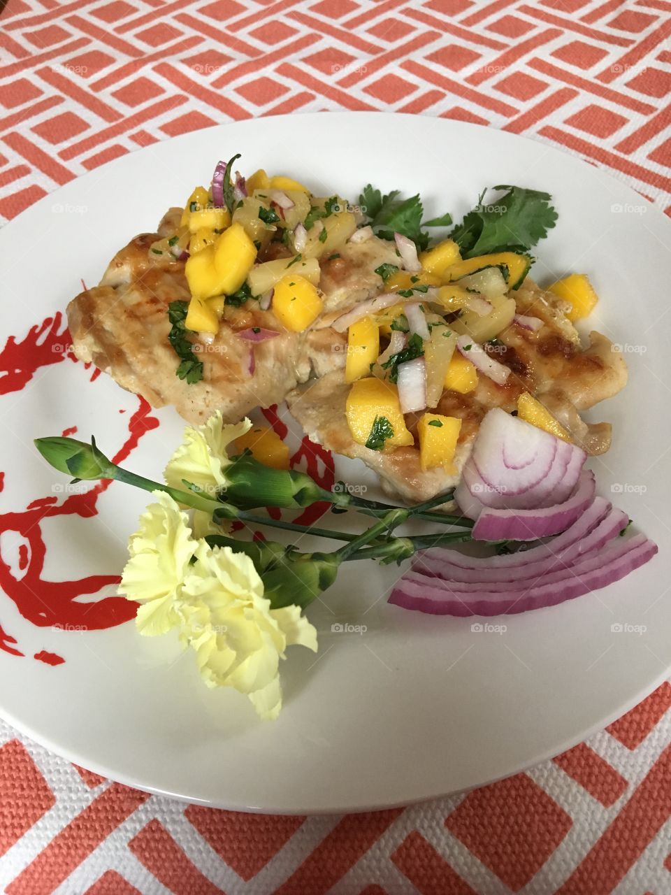 Garlic and ginger braised chicken thighs with pineapple mango salsa. 