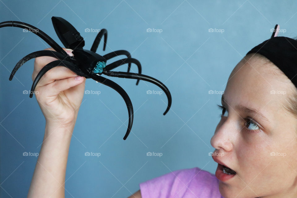 Child creating Lego spider