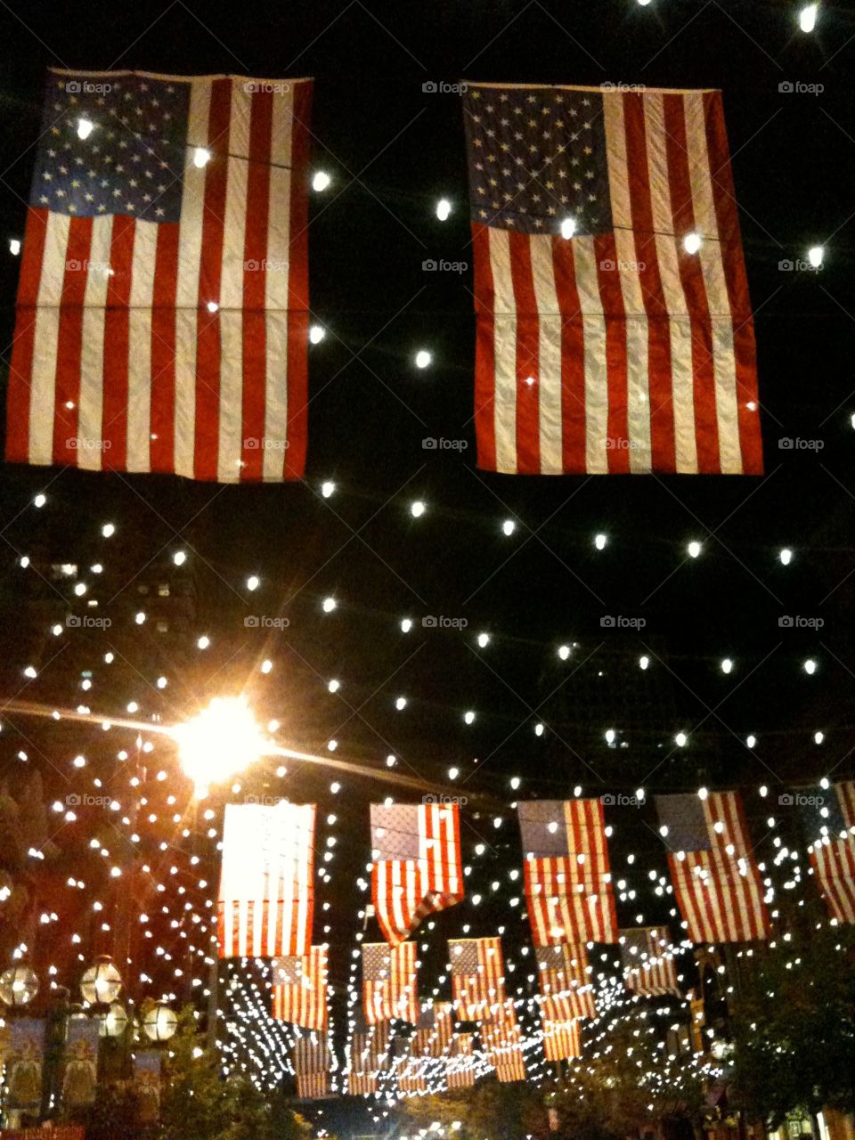 4th of July. American flags hanging at night. 