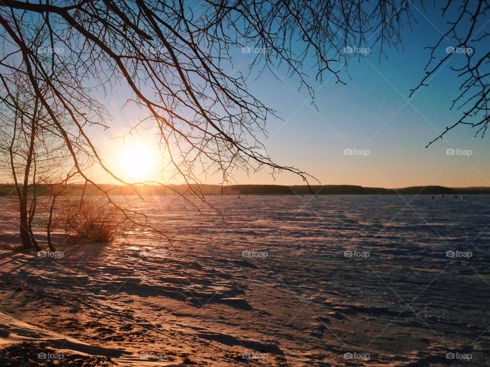 Winter sunset on the frozen lake