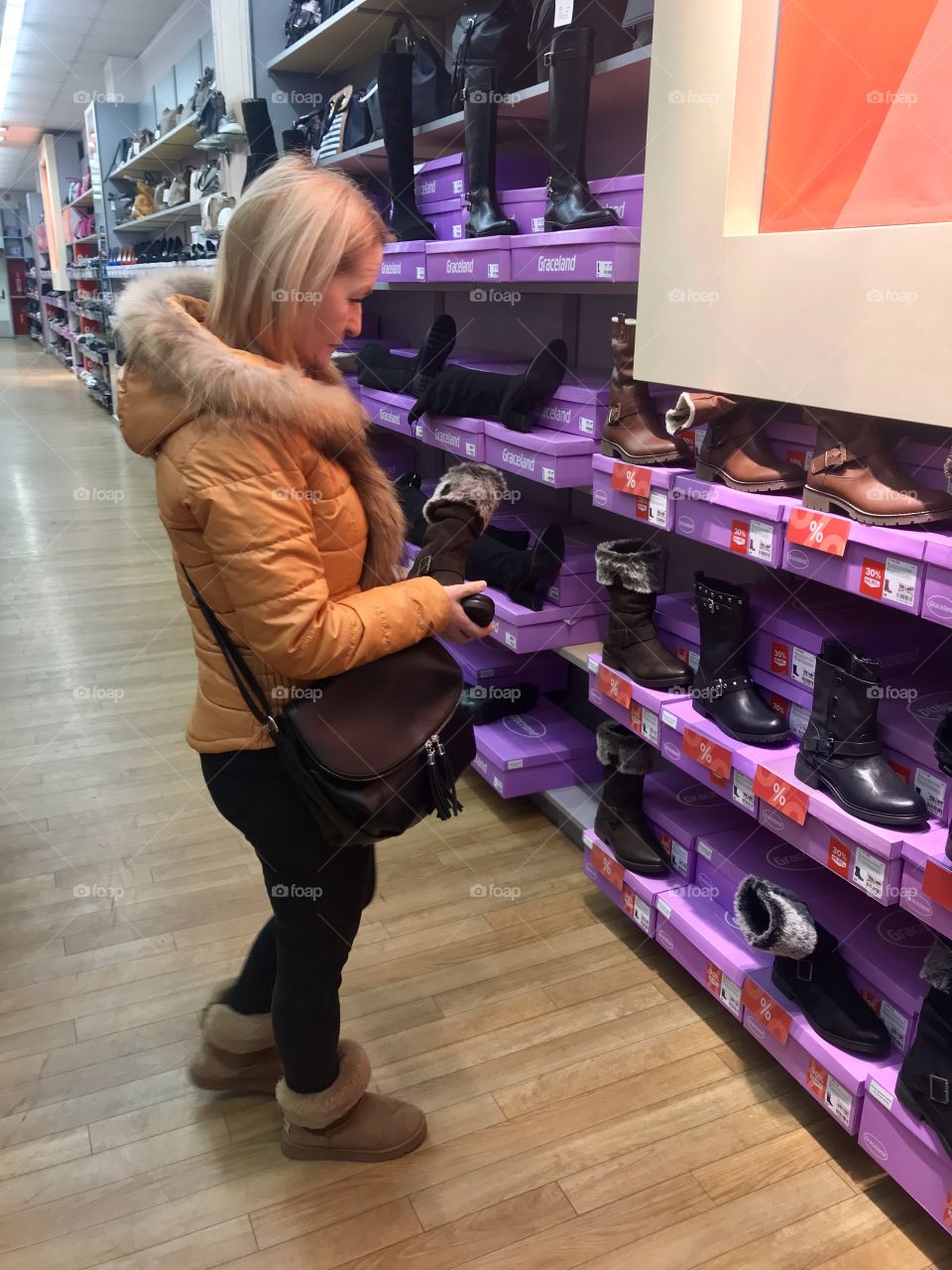 A woman is trying to find a new pair of shoes.