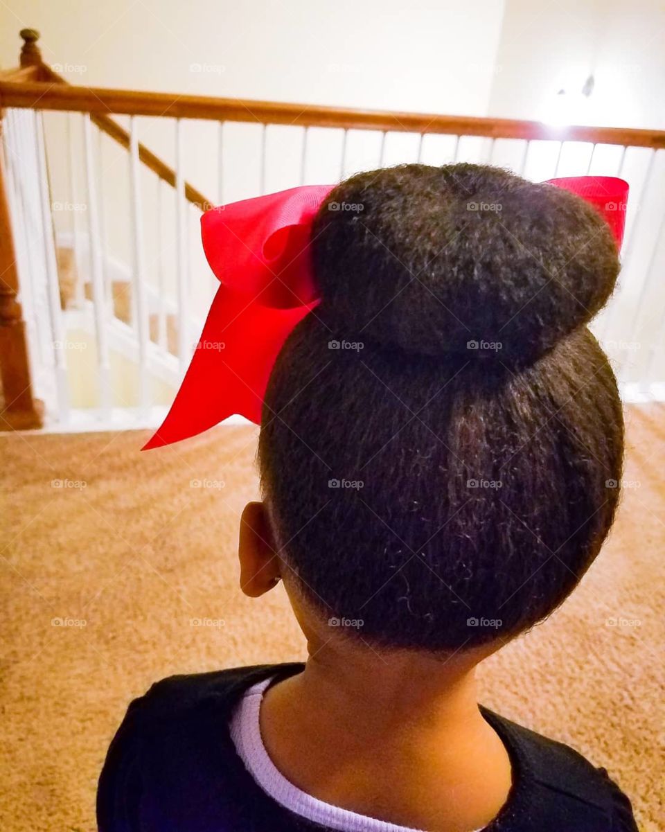 Little girl's hair bun.