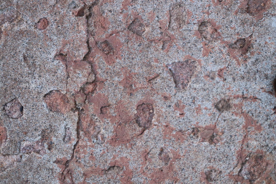 Portion of cement sidewalk in iron ore mining town, color as a result of fallout