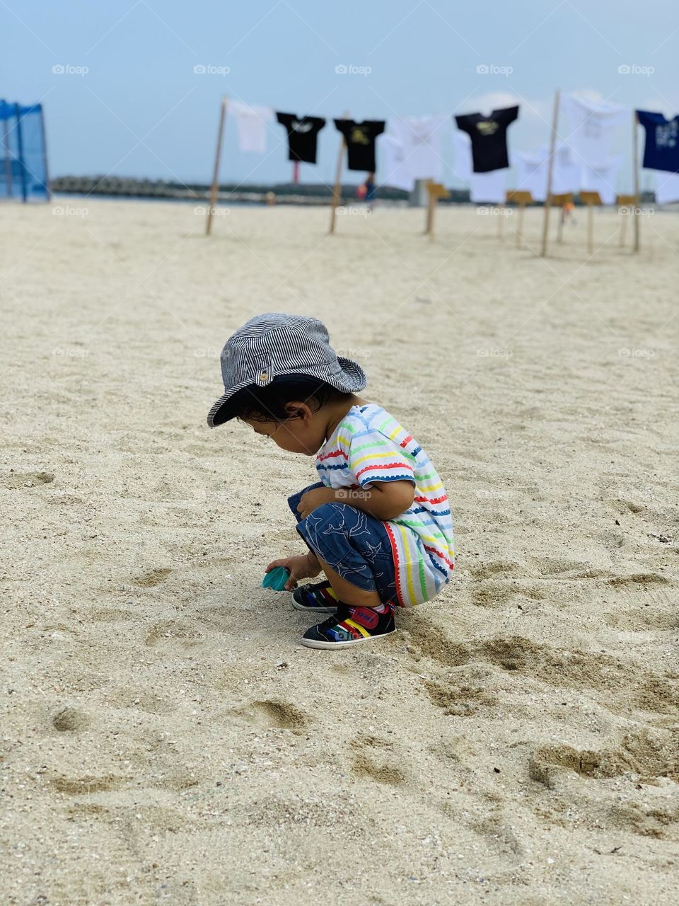 A kid is playing on the beach 