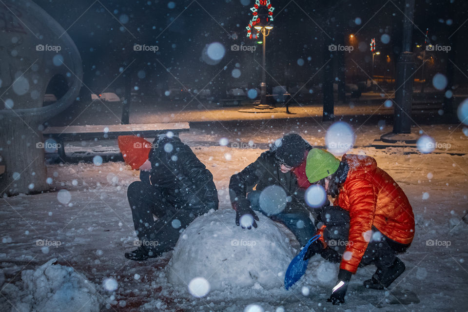 Making a Snow man during winter holiday