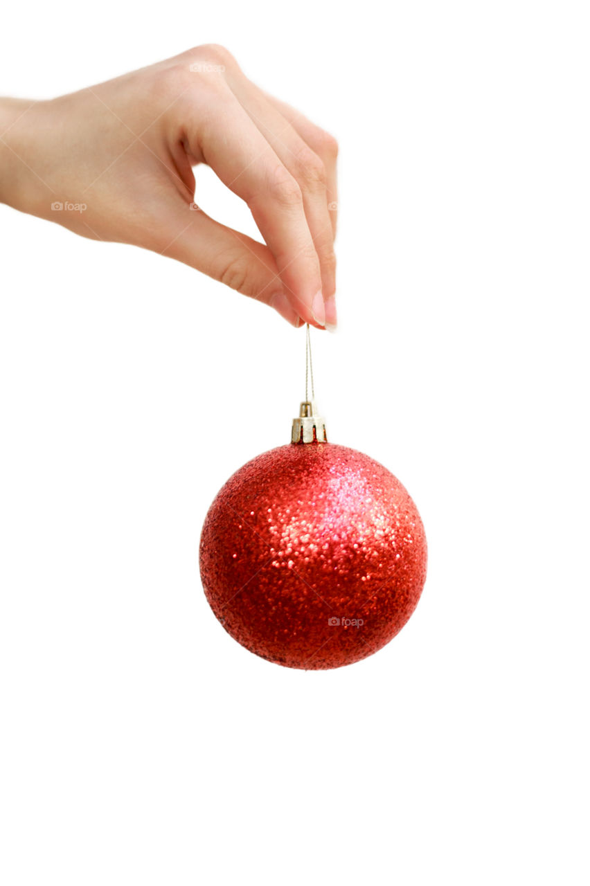 shiny Christmas ball on a string in his hand