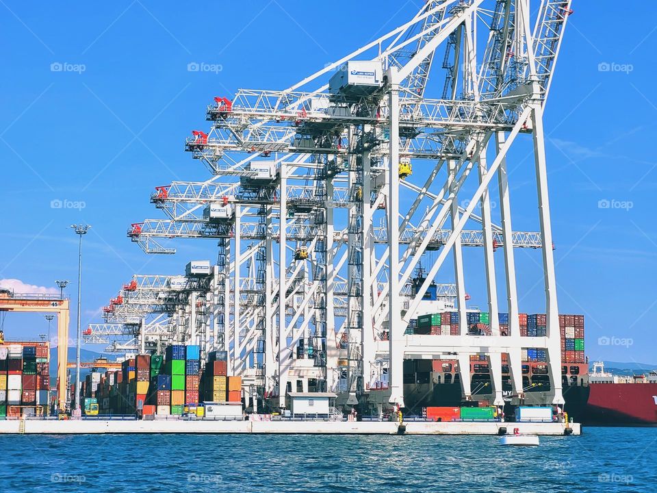 City view of Luka Koper at Adriatic seaside,  Slovenia.  Commercial cargo sea port with container cranes,  ships. Pilot boats.