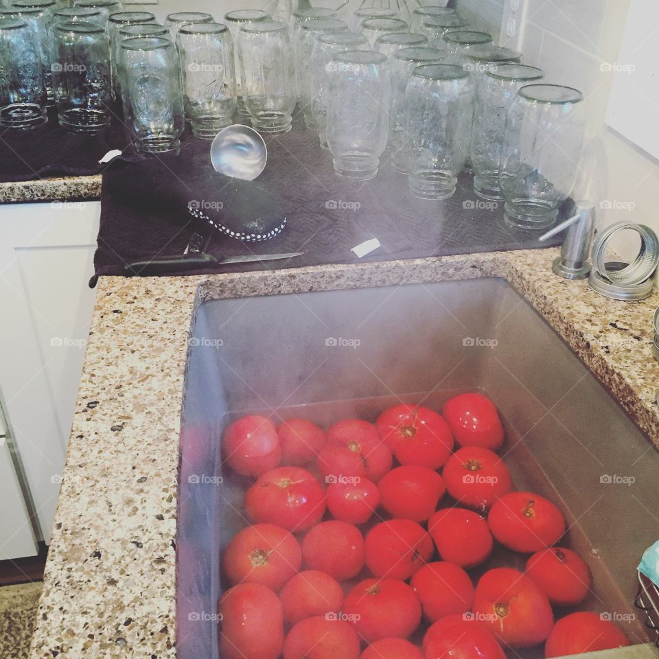 In the kitchen canning tomatoes 