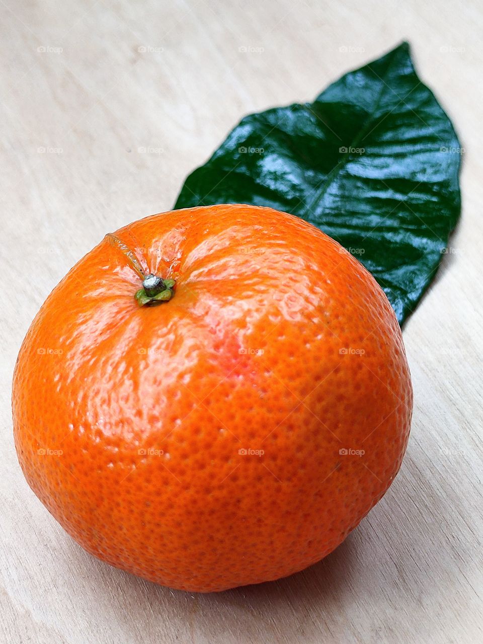 Orange tangerine and green tangerine leaf