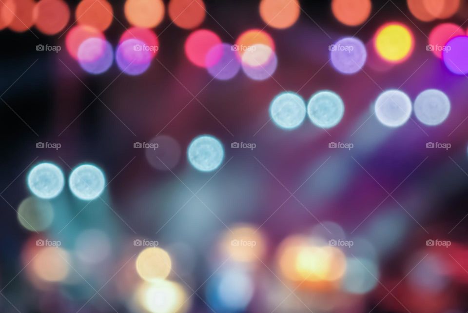Blurred, colourful circles of light from a rock concert stage