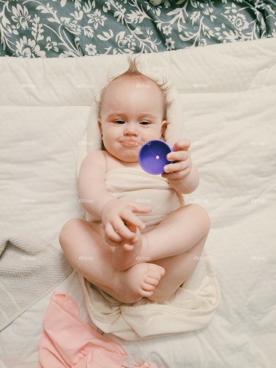 Cute baby-girl playing with a toy