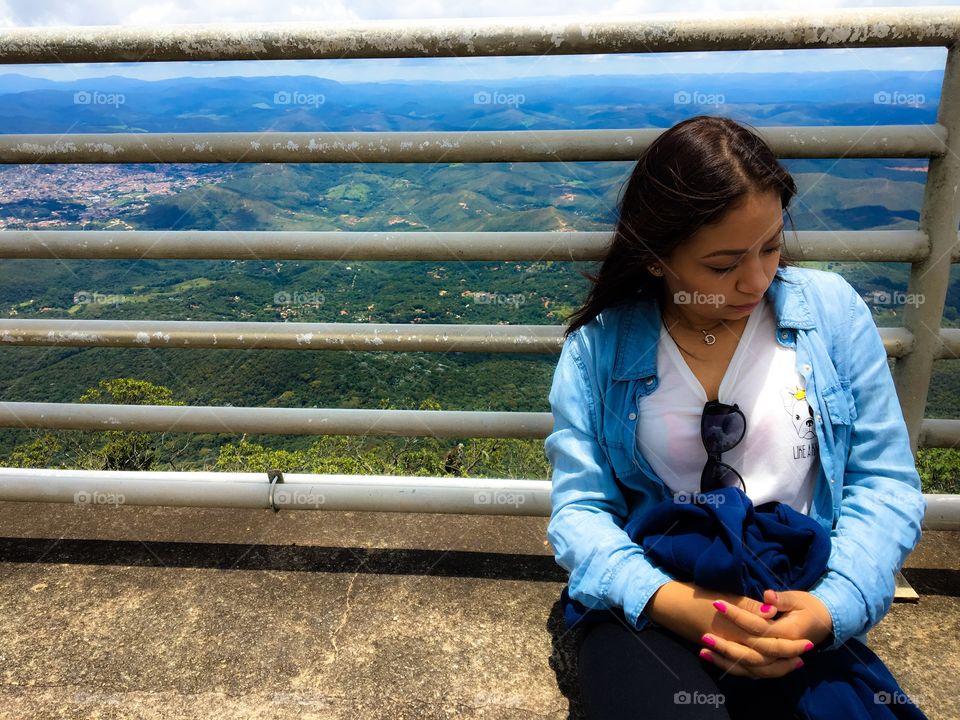 Close-up of a woman sitting on bridge