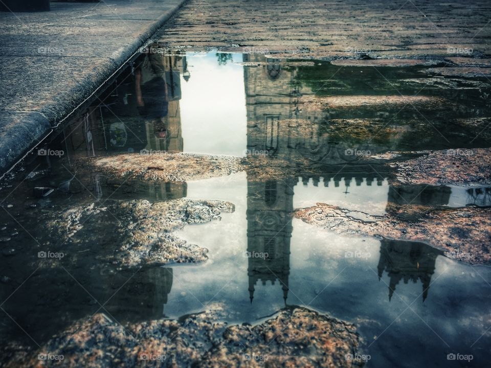 Notre-Dame Basilica in Old Montréal reflected in rain puddle