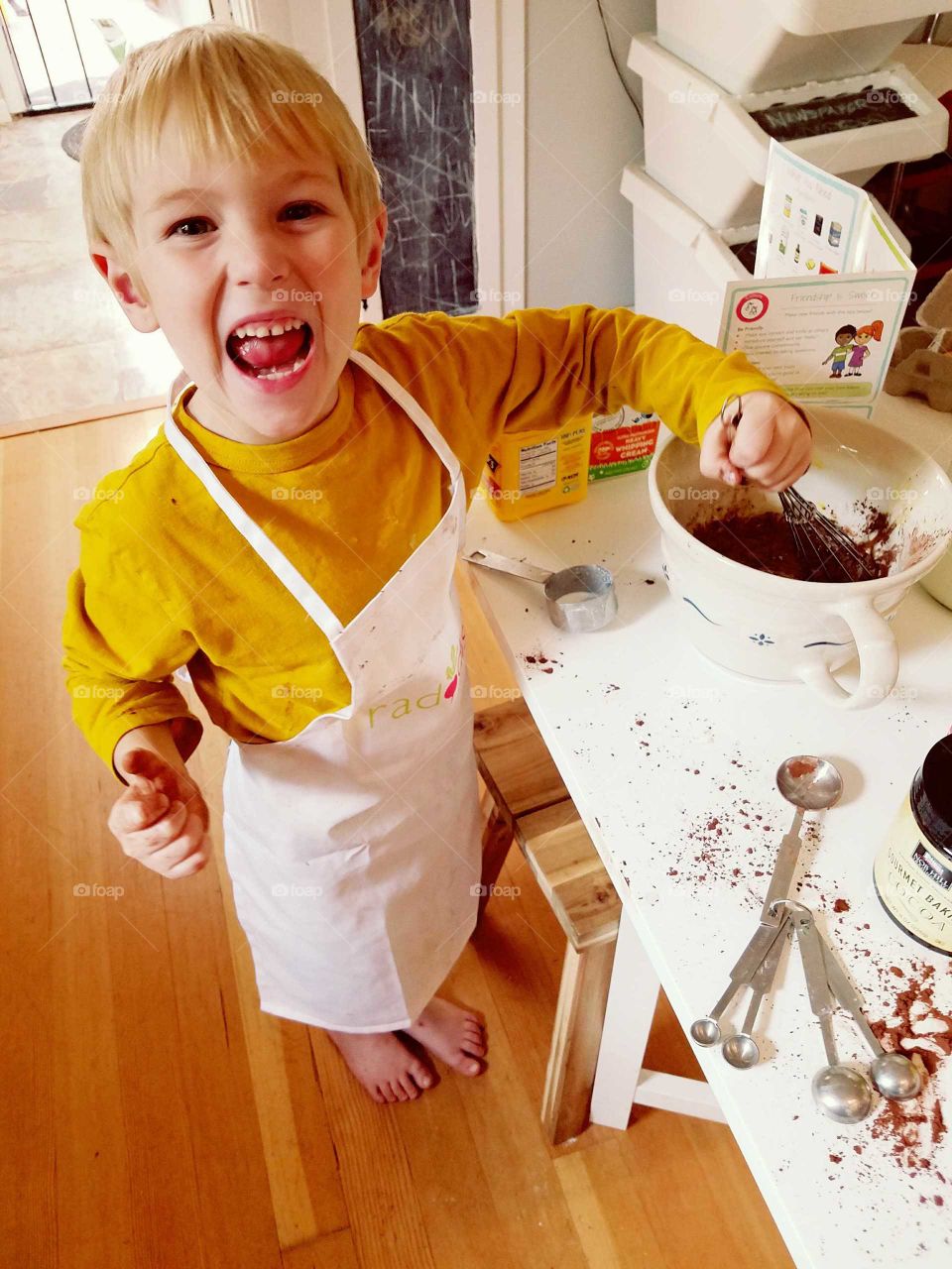 boy having fun making chocolate pudding from scratch