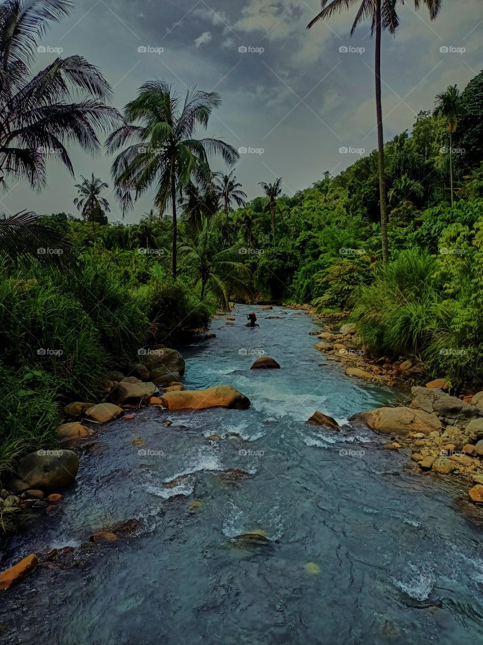 Panoramic landscape of bright blue river of dua rasa river and tropical rain forest