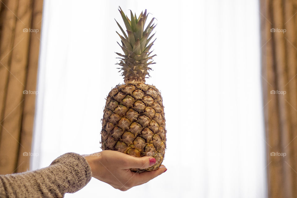 Woman holding a pineapple