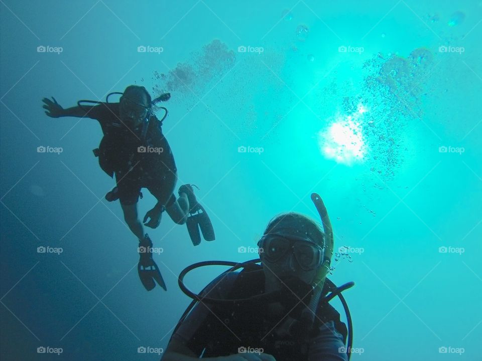 Man and woman snorkeling underwater in the sea